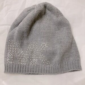 Michael Kor hat. Grey with silvery rings designs for MK logo